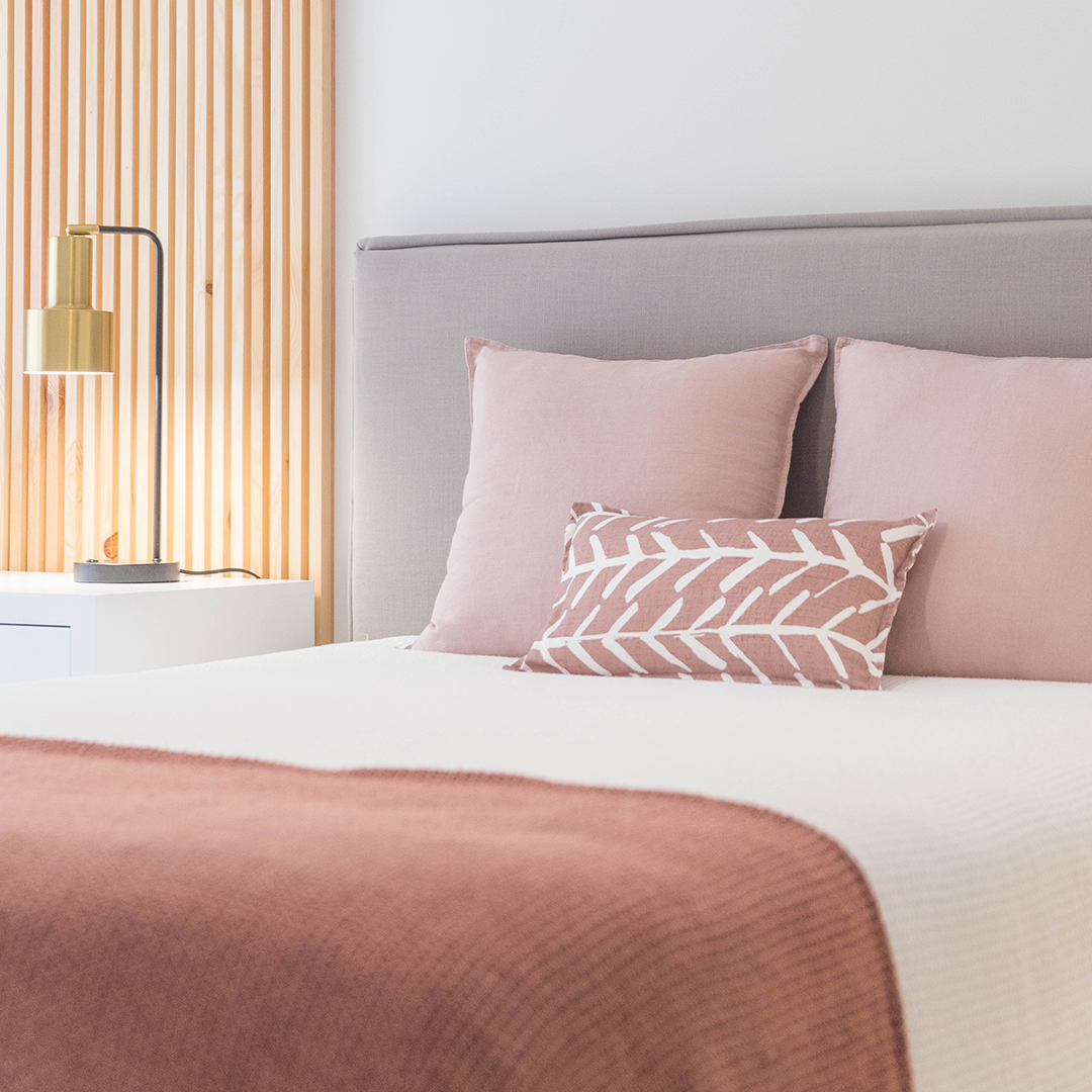 Bed with pink throw pillows